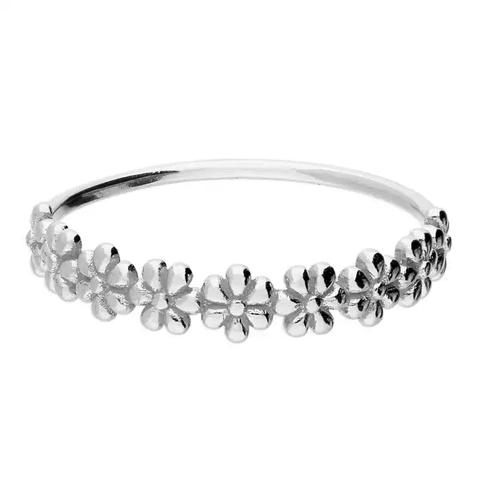 Silver bangle with floral designs on a white background