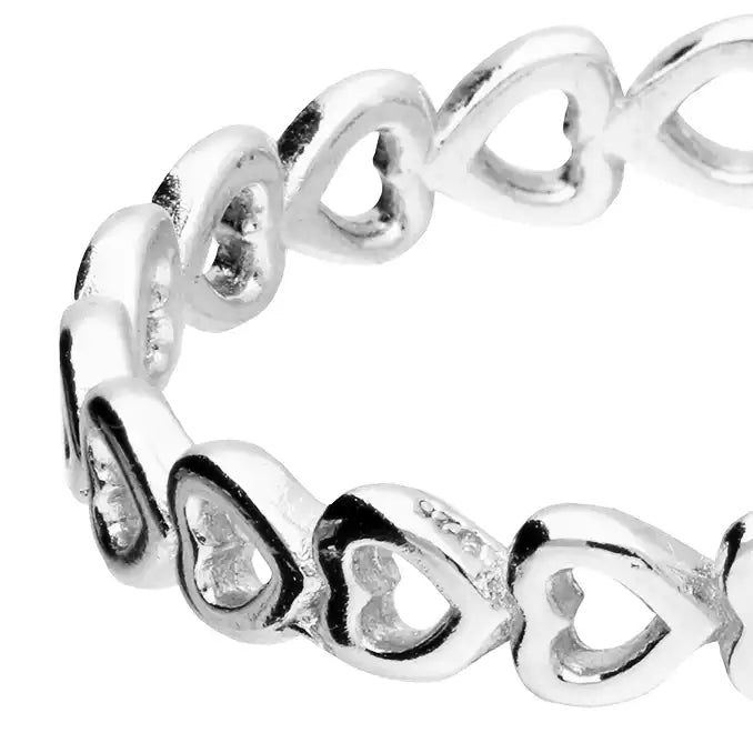Silver ring with heart designs on a white background