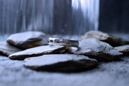 A unique, handcrafted sterling silver ring with a hammered texture, featuring a wide 5mm band and 2mm thickness. Each ring is custom-made with distinctive contours.