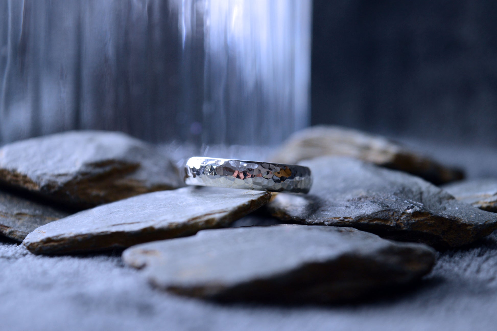 A handcrafted 925 sterling silver ring with a textured, hammered finish. The band measures 5mm in width and 2mm in thickness, offering a unique, custom-made design.