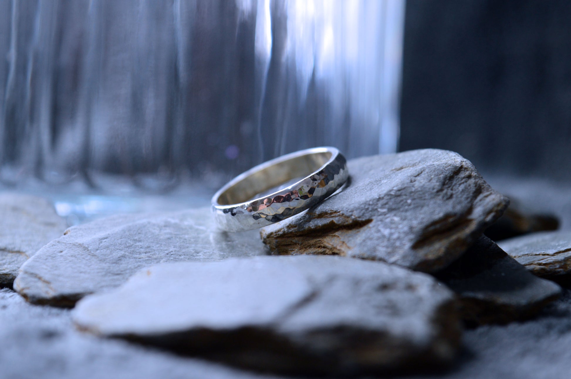 Close-up of hammered 4 x 2mm sterling silver band, showcasing textured contours.