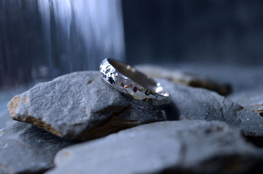 Handmade 4 x 2mm hammered sterling silver ring with unique texture and pattern.