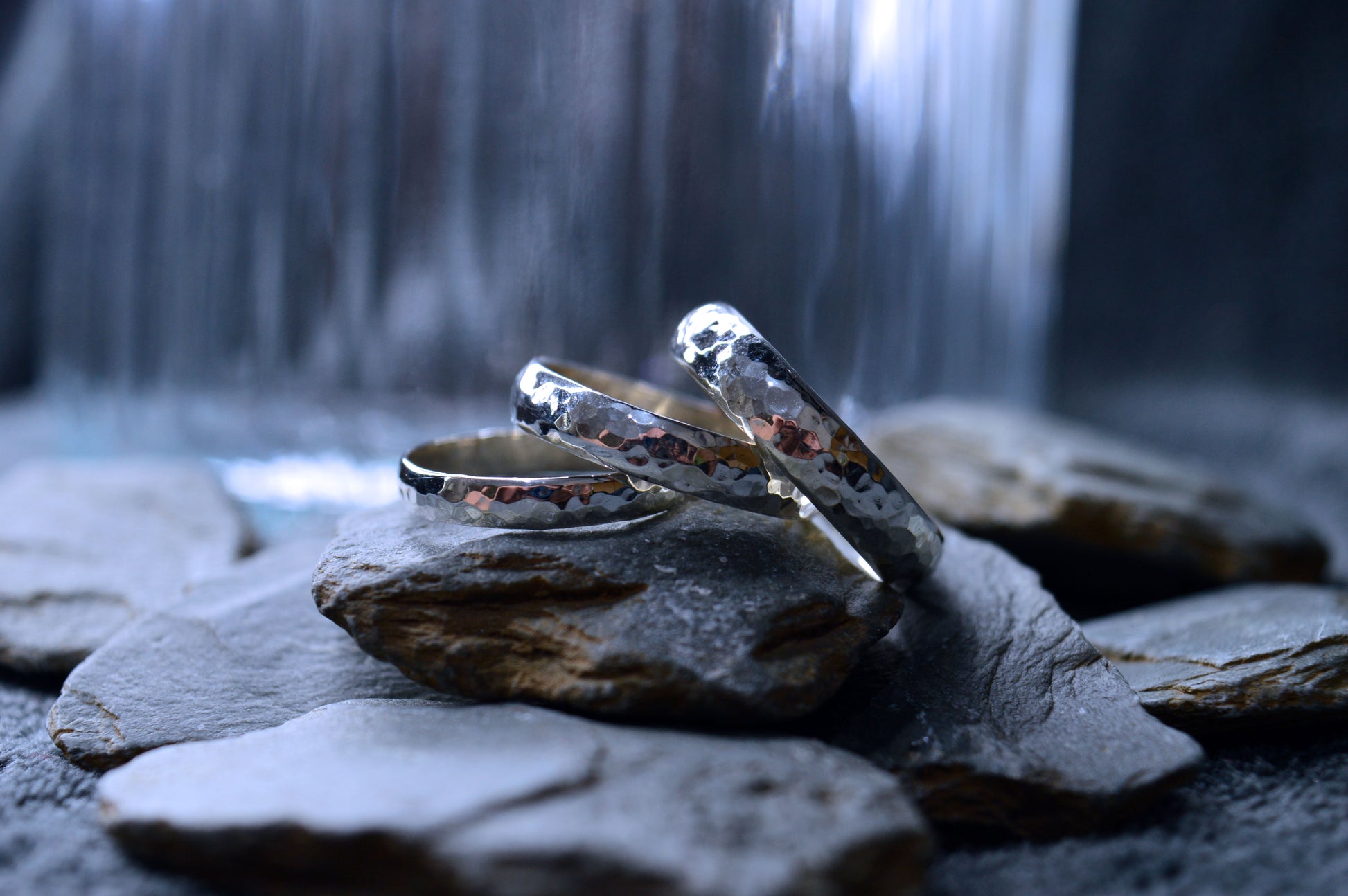 A polished sterling silver ring with a distinctive hammered surface. Measuring 5mm by 2mm, this handmade ring is crafted to order, making each piece one of a kind.