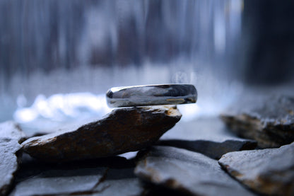 Close-up of handcrafted 4 x 2mm silver wedding band, showcasing sleek and timeless design.