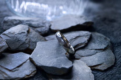 A shiny 925 sterling silver wedding band with a simple, traditional design. The 5mm wide and 2mm thick ring is handcrafted to order.