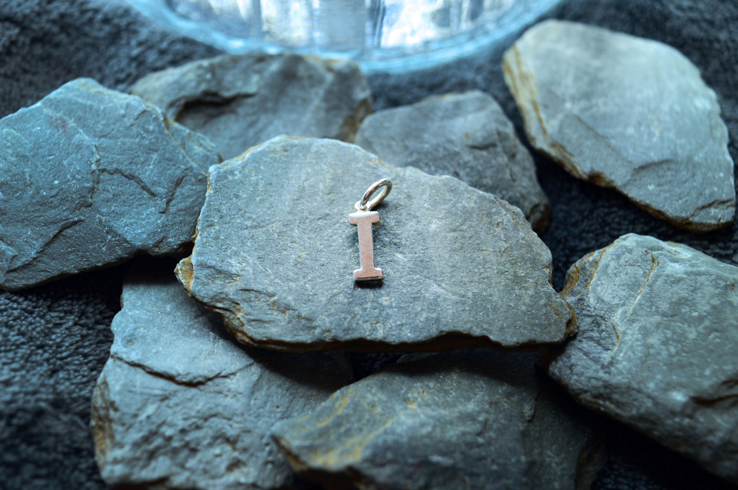 Handmade silver initial pendant, showcasing a 1.5mm thick letter with a 5.5mm external loop for easy attachment.