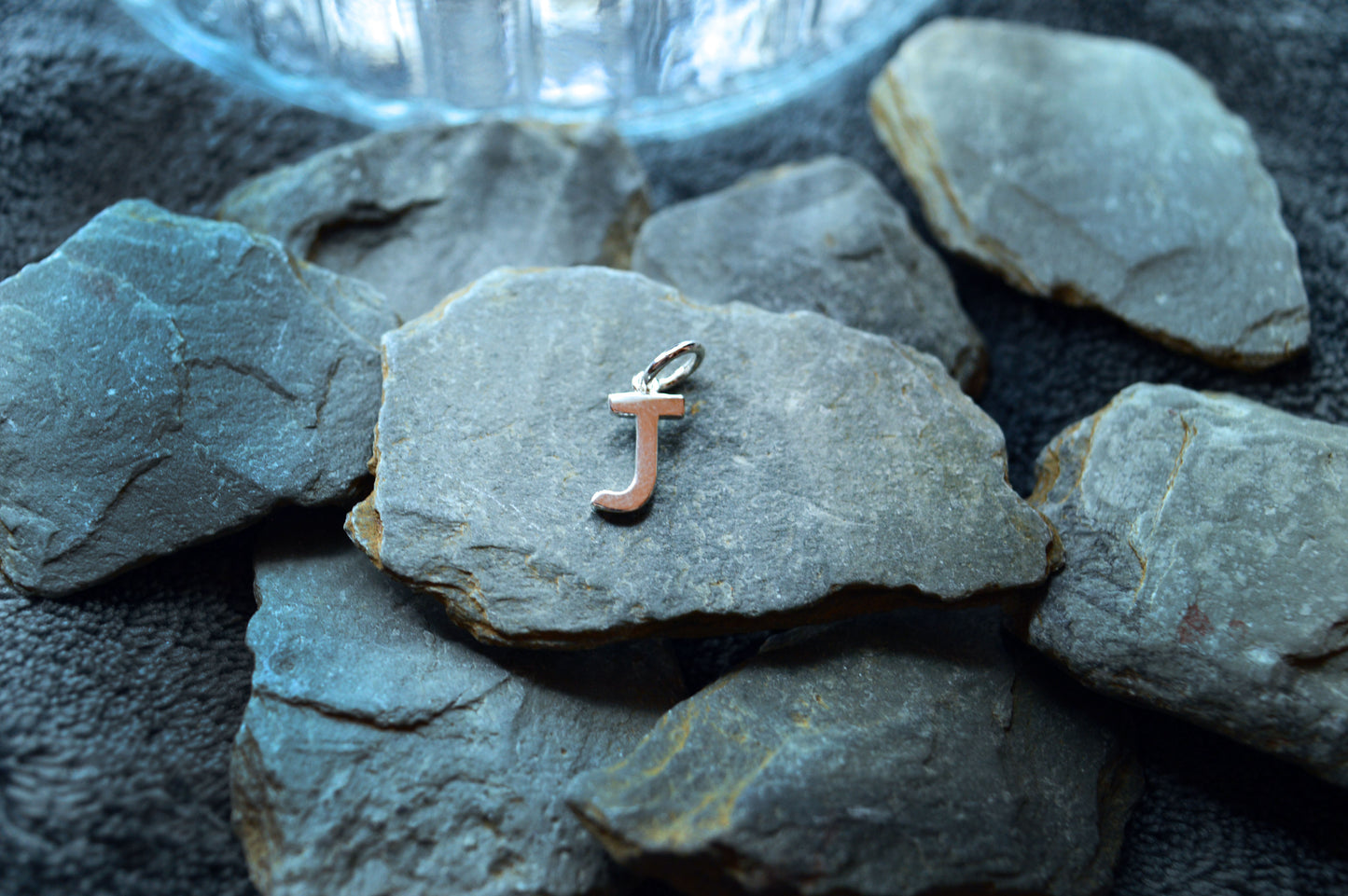 Polished sterling silver initial pendant, perfect for customizing a necklace. The letter is 10mm tall with a 3.5mm loop.