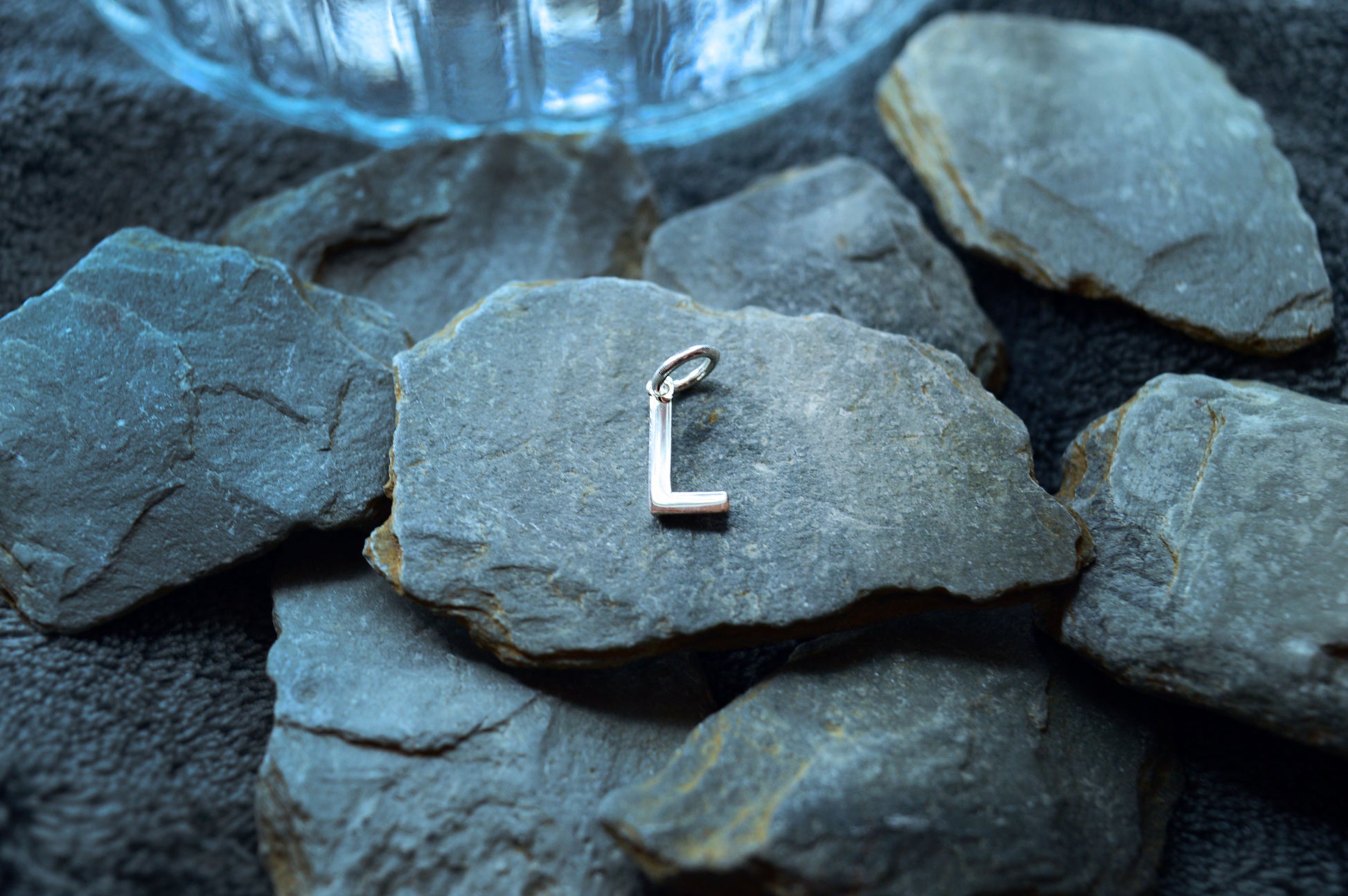 Close-up of a 925 silver letter pendant with a polished finish and 3.5mm loop, ideal for small necklace chains.