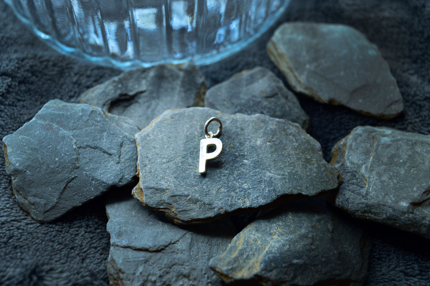 Handcrafted silver initial pendant with a smooth finish and pre-looped hole, designed for necklaces up to 3mm thick.