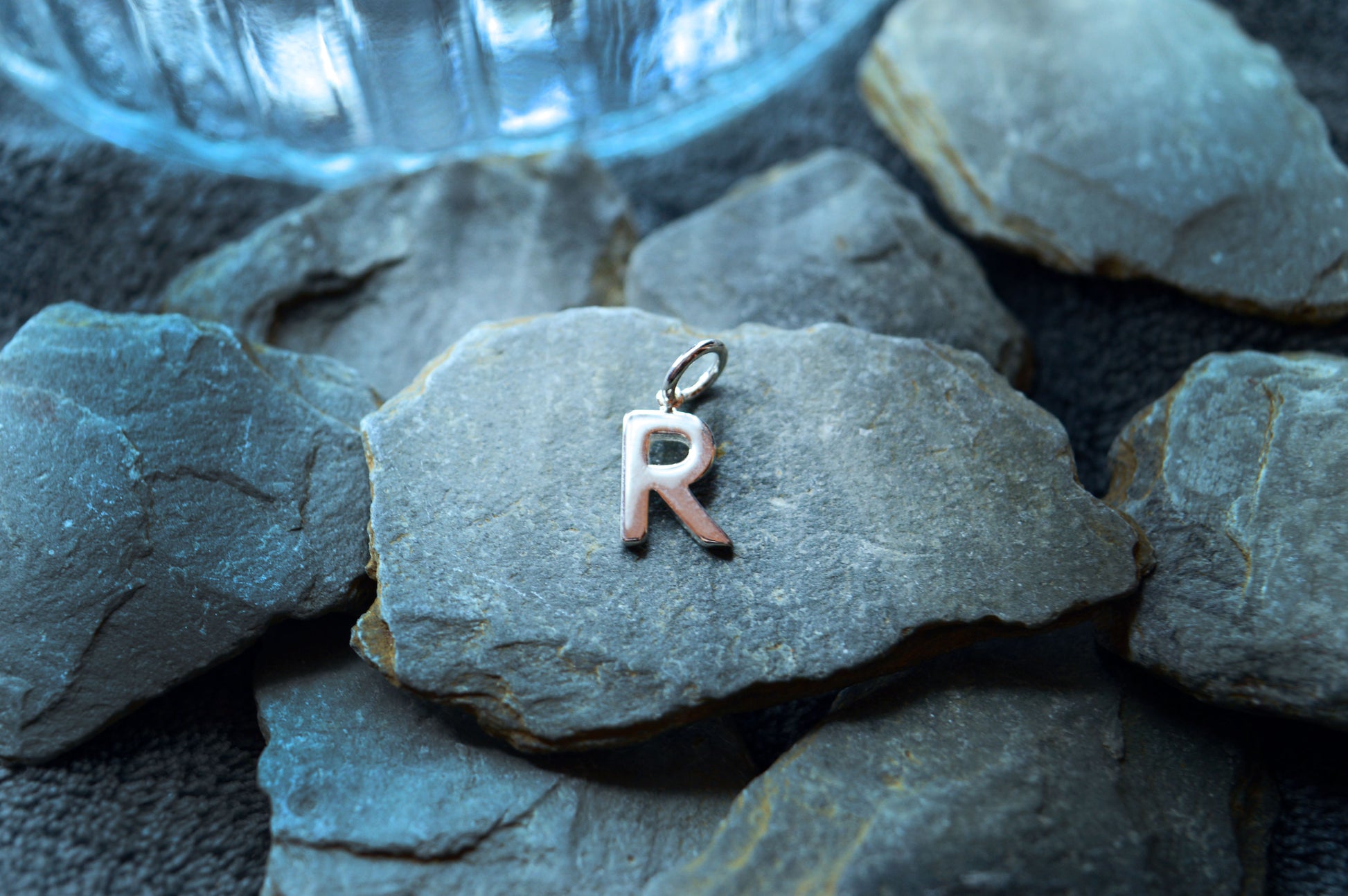 Small and elegant sterling silver letter pendant with a 1.5mm thick design and 3.5mm internal loop diameter.