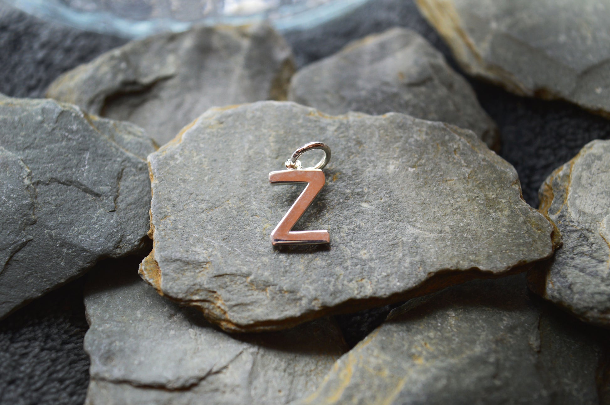 Elegant sterling silver initial pendant with a polished finish, measuring 10mm in height and featuring a 3.5mm loop.