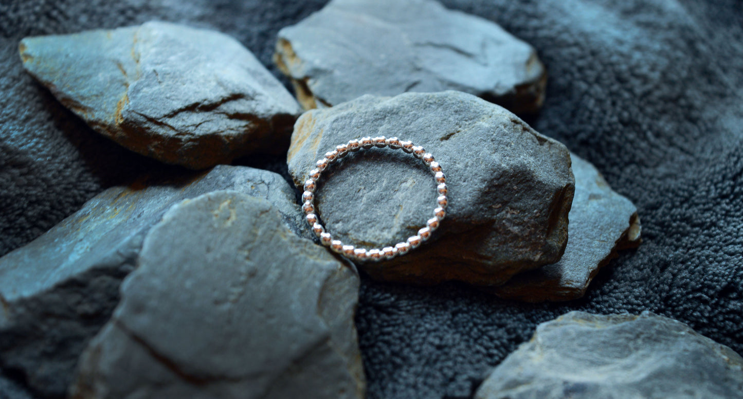 Stylish 925 sterling silver beaded ring showcasing a simple, 2mm band. Perfect for adding a touch of elegance to any ring stack or wearing solo.