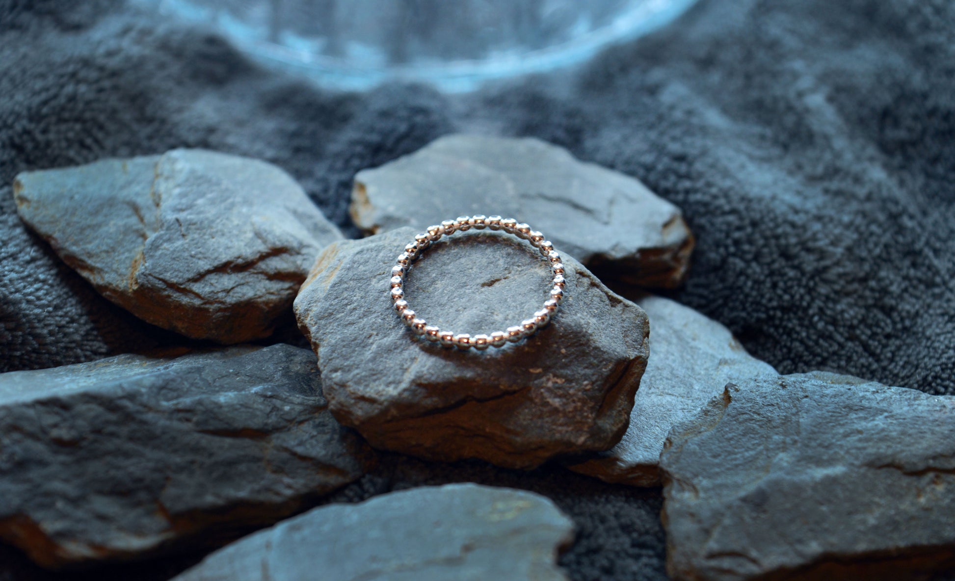 Detailed view of a dainty 925 sterling silver beaded ring with a minimalist design. The 2mm wide band is designed for effortless stacking.